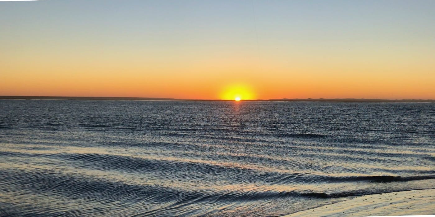 Coucher de soleil avec canne en silhouette — surfcasting Maroc